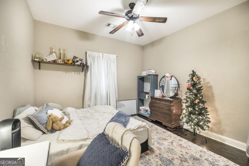 312 Bridgehampton Way Perry, GA 31069 - Photo 22 of 34 a bedroom with a bed and a chandelier