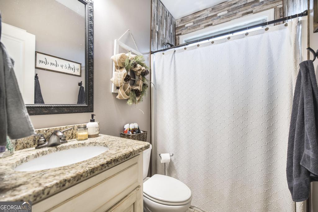 312 Bridgehampton Way Perry, GA 31069 - Photo 24 of 34 a bathroom with a granite countertop sink toilet and shower
