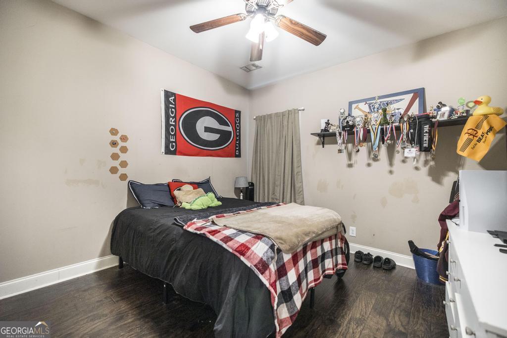 312 Bridgehampton Way Perry, GA 31069 - Photo 25 of 34 a bedroom with a bed and a chandelier