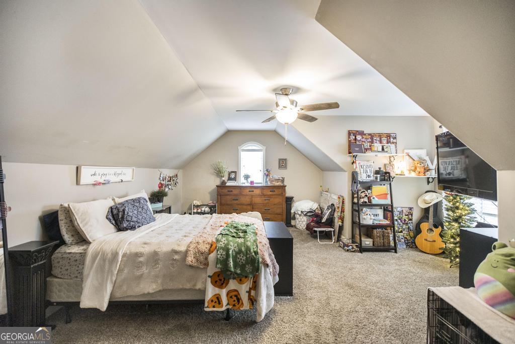312 Bridgehampton Way Perry, GA 31069 - Photo 27 of 34 a bedroom with furniture and a chandelier