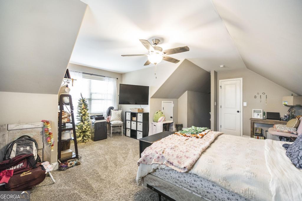 312 Bridgehampton Way Perry, GA 31069 - Photo 28 of 34 a bed room with a bed mirror and a flat tv screen on a dresser
