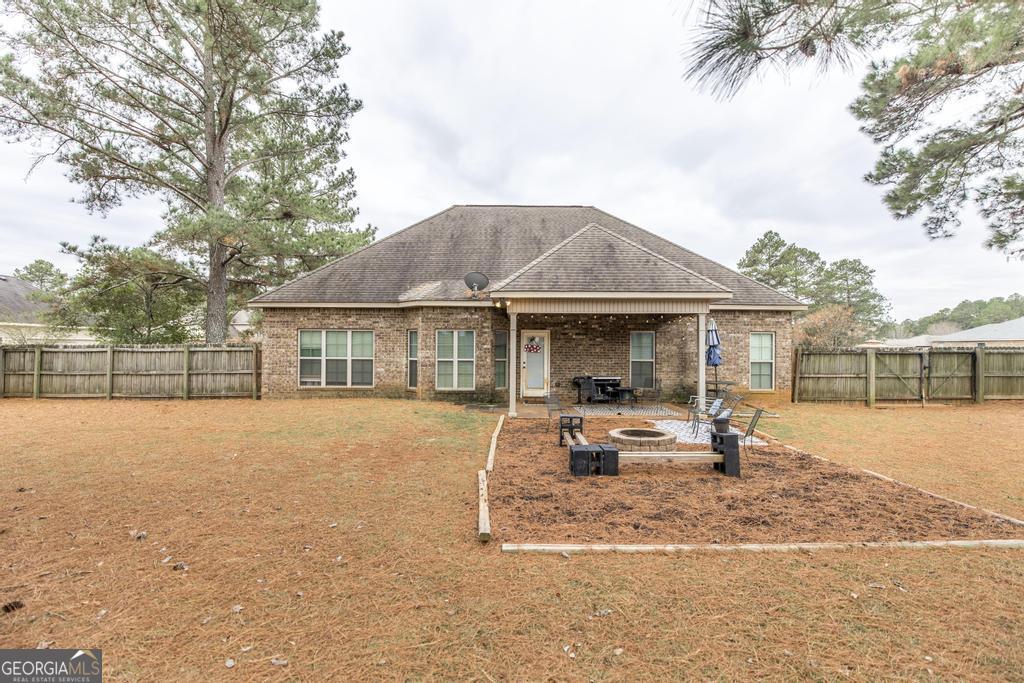 312 Bridgehampton Way Perry, GA 31069 - Photo 32 of 34 a front view of house with outdoor seating and barbeque oven