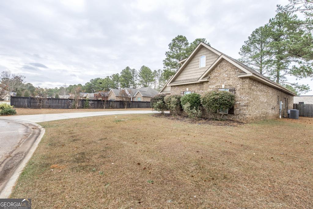 312 Bridgehampton Way Perry, GA 31069 - Photo 4 of 34 a view of a house with a yard and a large tree