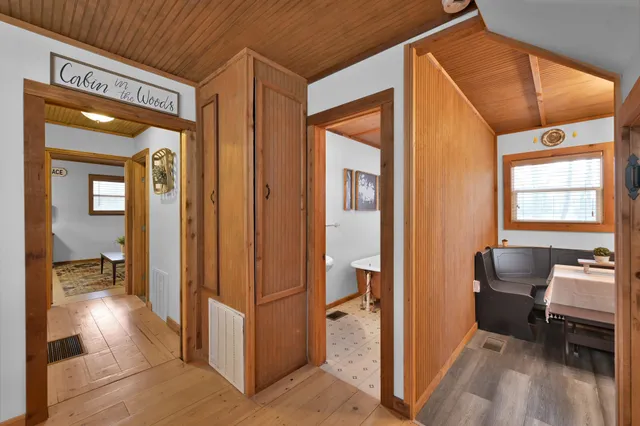a view of a hallway and a livingroom with furniture