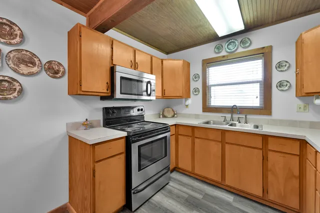 a kitchen with stainless steel appliances granite countertop a sink and a stove top oven