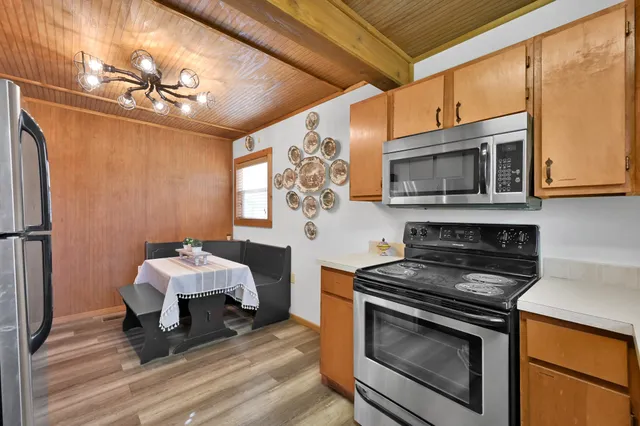 a kitchen with a sink appliances and cabinets