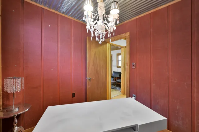 a bedroom with a bed and a chandelier