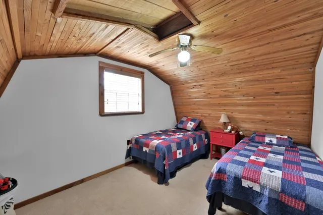 a bedroom with two beds and a chandelier