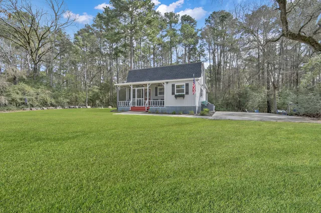 a front view of house with yard and green space