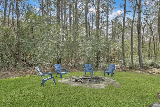 a backyard of a house with table and chairs