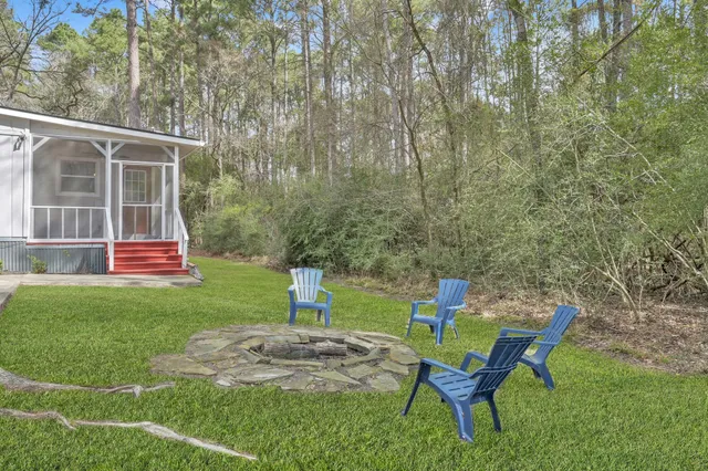 a backyard of a house with table and chairs
