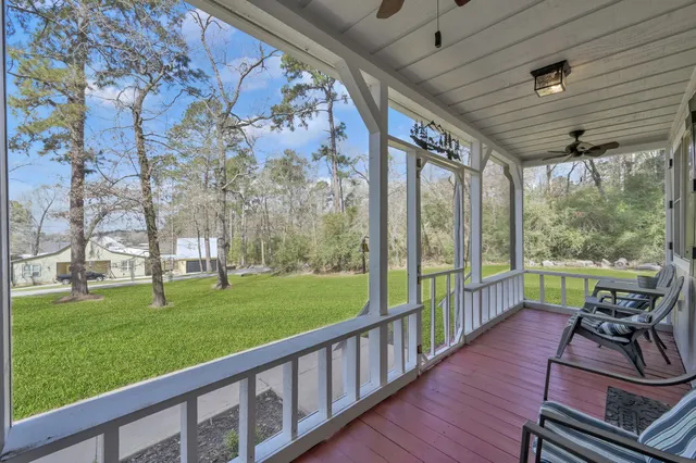 a view of a porch with furniture and garden