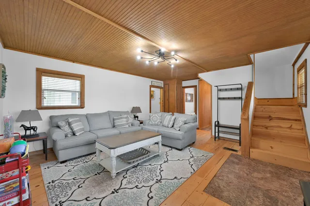 a living room with furniture and a chandelier