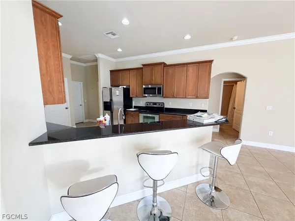 a kitchen with stainless steel appliances a refrigerator and microwave