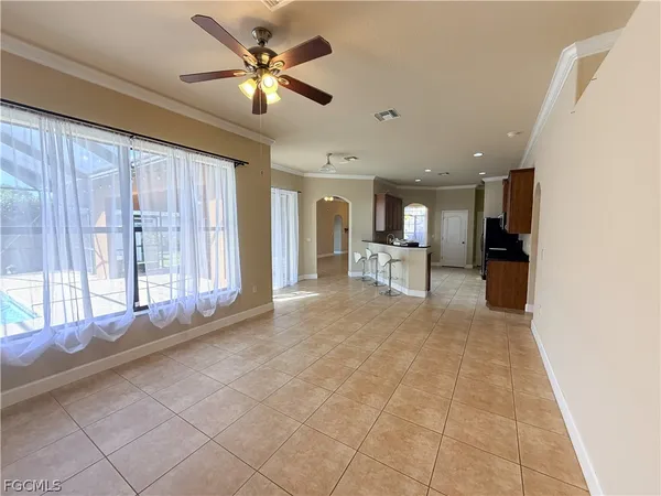 a view of an empty room with a kitchen