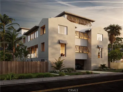 a front view of a house with plants