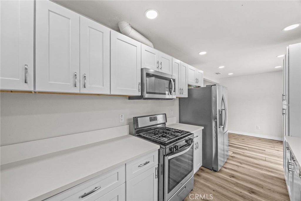 10028 Primrose Drive Riverside, CA 92503 - Photo 7 of 19 a kitchen with stainless steel appliances granite countertop a refrigerator and a stove