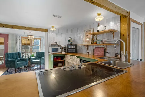 a kitchen with stainless steel appliances granite countertop a sink stove and cabinets
