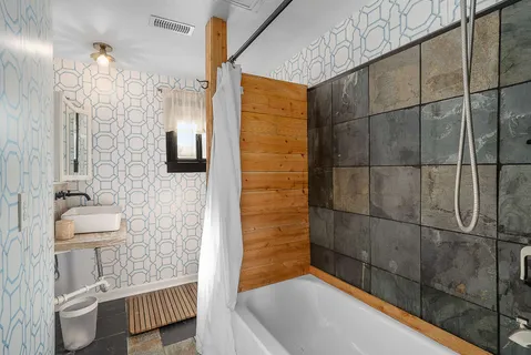 a bathroom with a bathtub and a shower