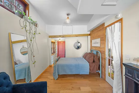 a bedroom with a bed and a window