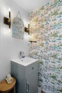 a bathroom with a sink a toilet and mirror