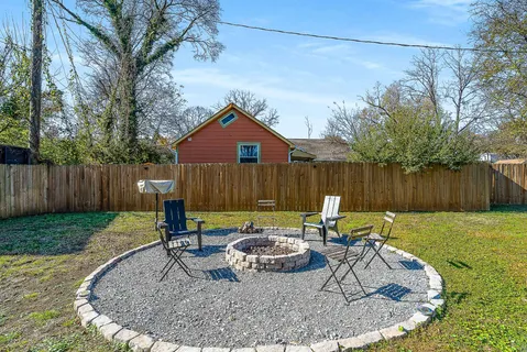 a backyard of a house with yard and outdoor seating