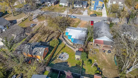 an aerial view of a houses with yard