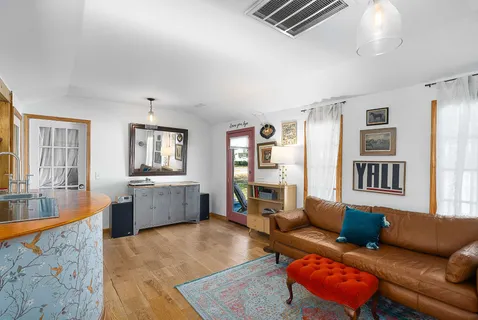 a living room with furniture and a wooden floor