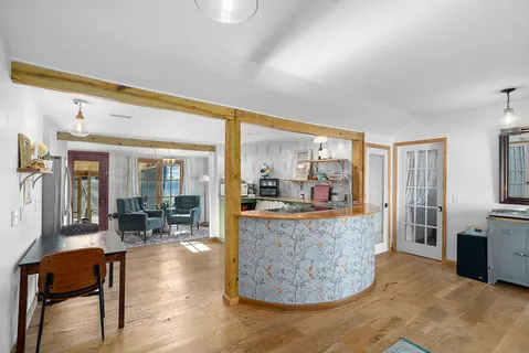 a living room with fireplace furniture and a large window