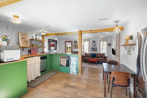 a living room with furniture and a kitchen