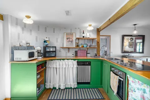 a kitchen with kitchen island a sink stove and cabinets