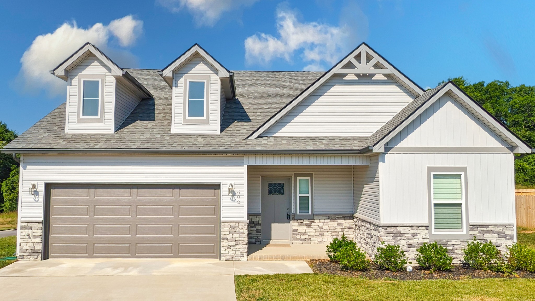 a front view of a house with a yard