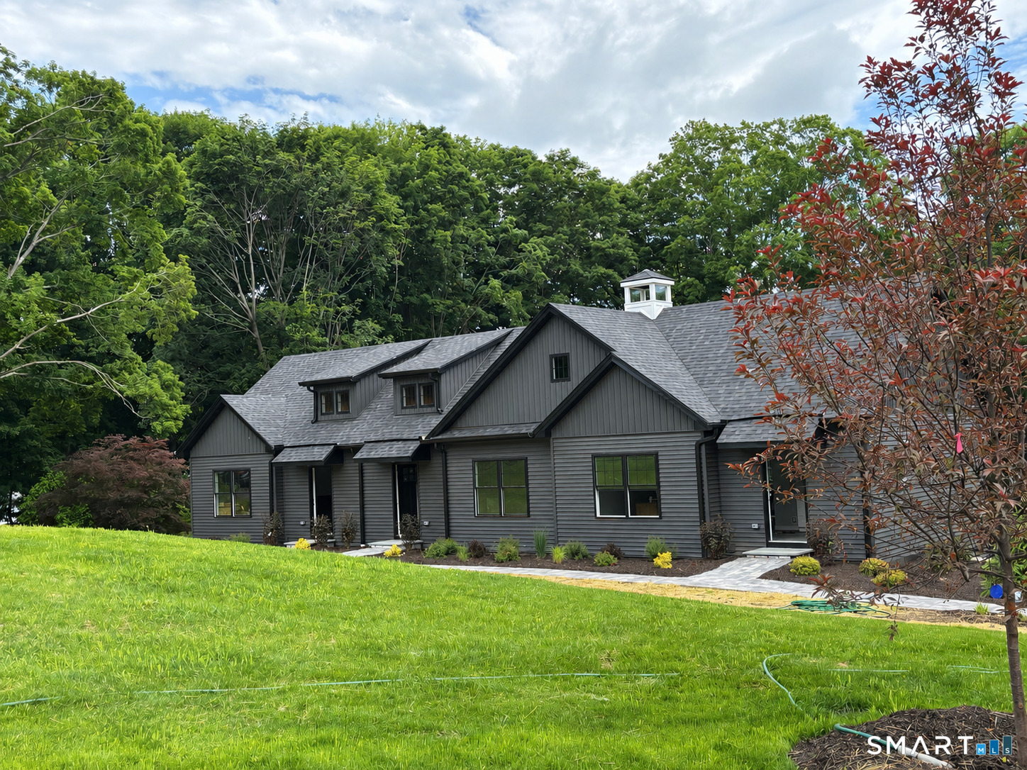 9 Putnam Park Road Bethel, CT 06801 - Photo 1 of 16 a front view of a house with a garden and porch