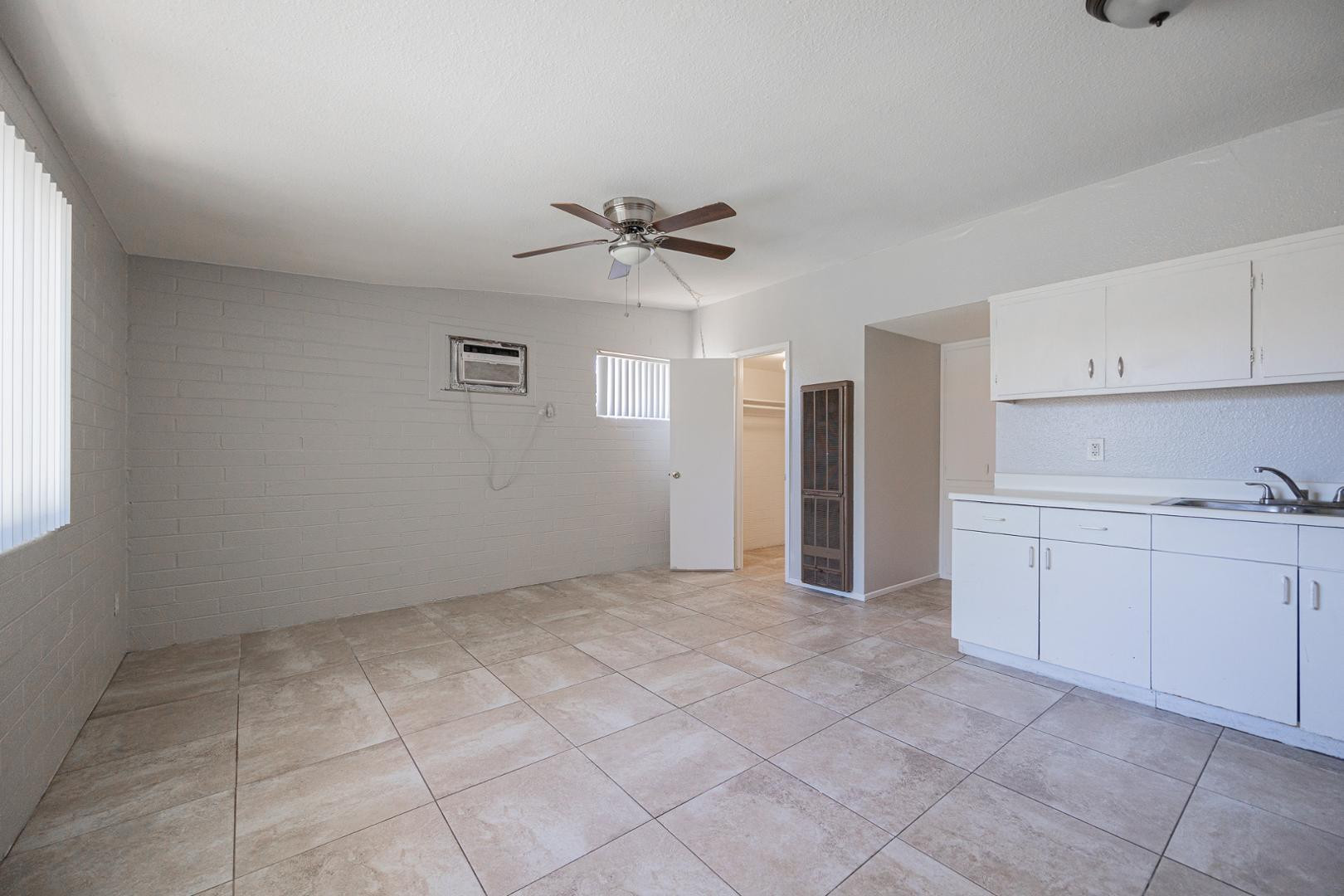 1017 South Mariana Street, Unit 3 Tempe, AZ 85281 - Photo 4 of 9 a view of a kitchen with a sink and dishwasher cabinets