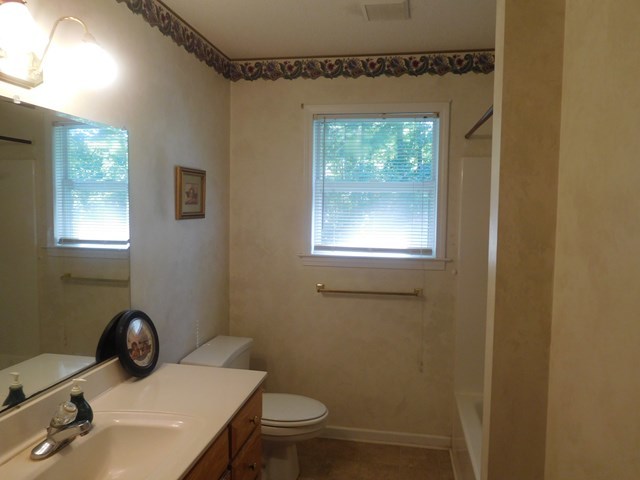 6905 Lower Thomaston Road Macon, GA 31220 - Photo 17 of 18 a bathroom with a sink a toilet and a mirror