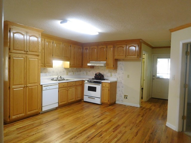 6905 Lower Thomaston Road Macon, GA 31220 - Photo 10 of 18 a kitchen with stainless steel appliances granite countertop a refrigerator a sink dishwasher a stove with wooden cabinets and floor