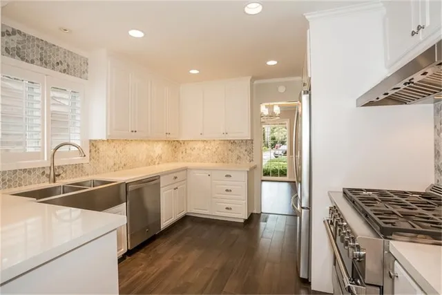 a kitchen with a stove a sink and a refrigerator