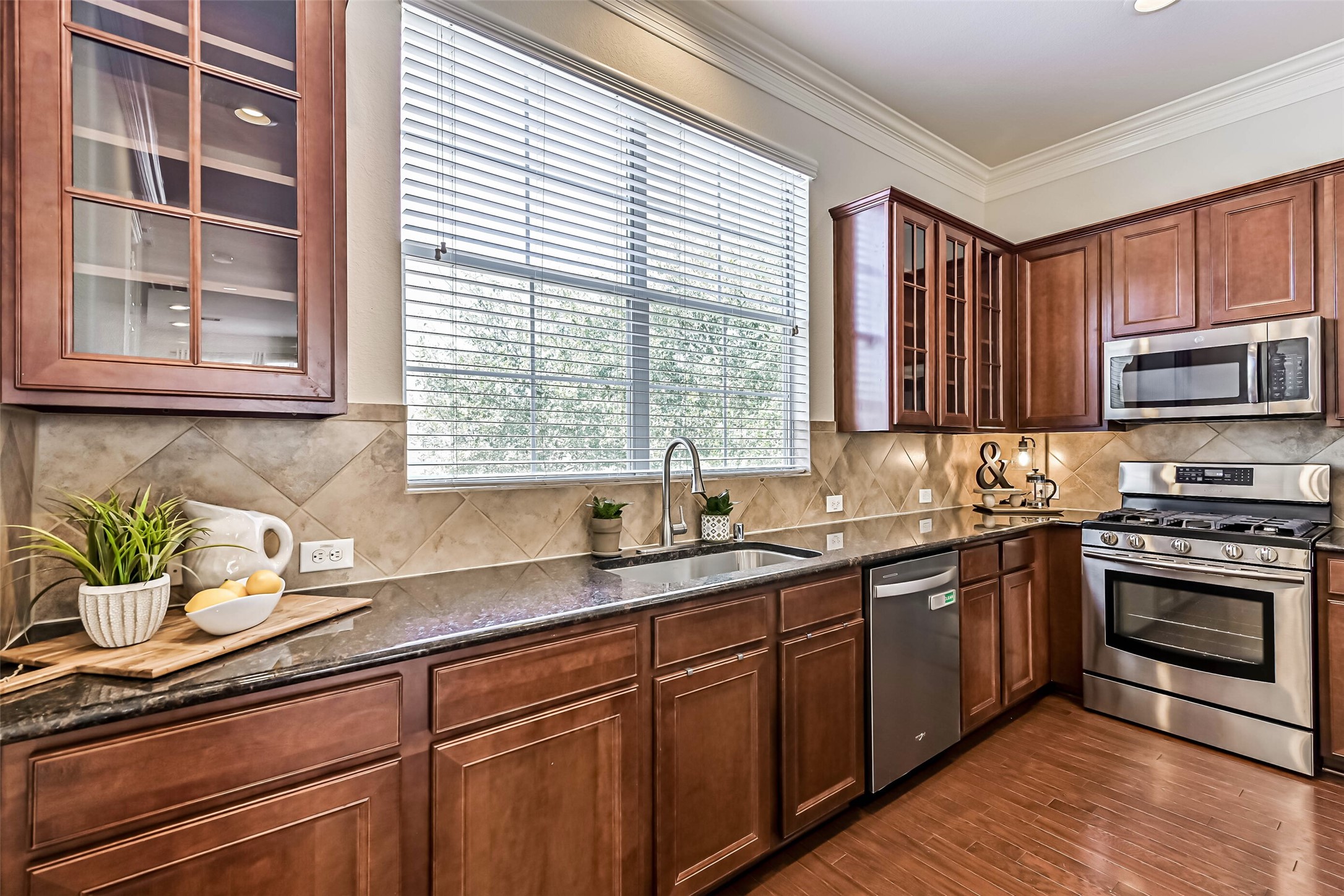 3208 Clearview Circle Houston, TX 77025 - Photo 15 of 30 a kitchen with stainless steel appliances granite countertop a sink a stove cabinets and a window