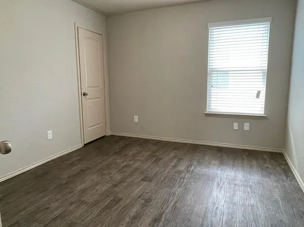 an empty room with wooden floor