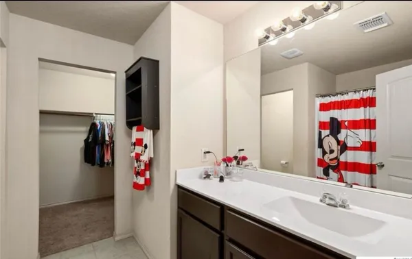 a kitchen with granite countertop a sink a center island and cabinets