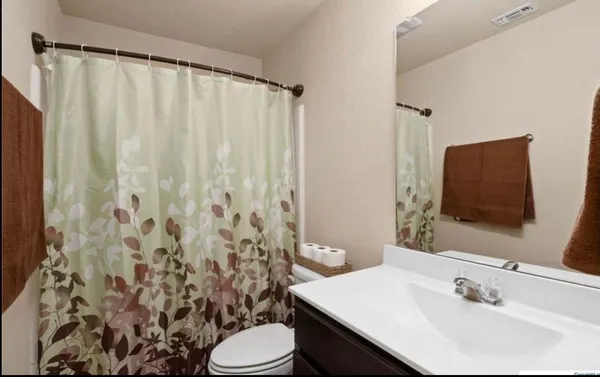 a bathroom with a sink vanity and a mirror