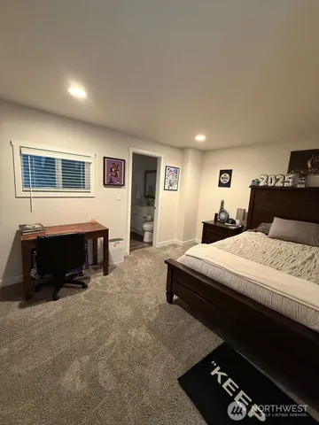 a bedroom with bed and a night stand