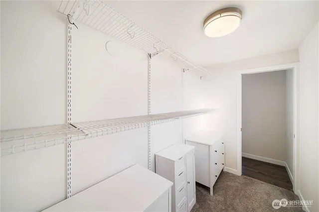 a view of walk in closet with empty racks