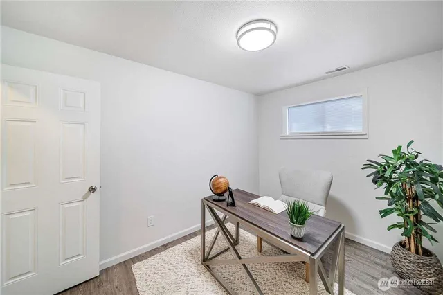 a workspace with furniture and wooden floor