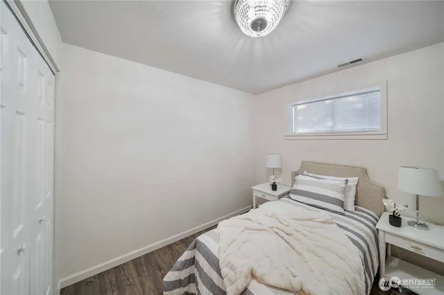 a bedroom with a bed and a painting on the wall