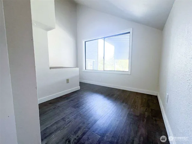 a view of a room with wooden floor