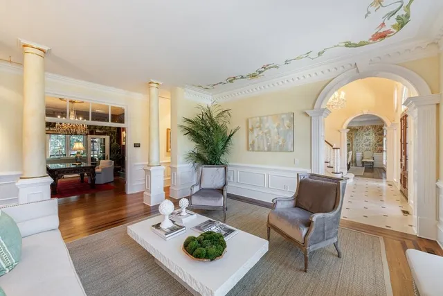 a view of a livingroom with furniture window wooden floor and fireplace