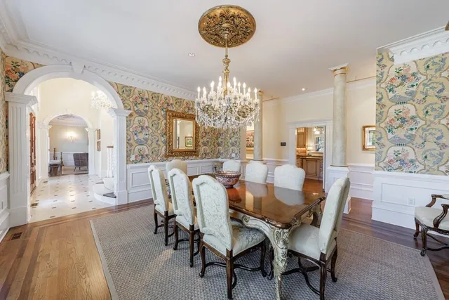 a kitchen with granite countertop a stove a oven a sink dishwasher and white cabinets with wooden floor