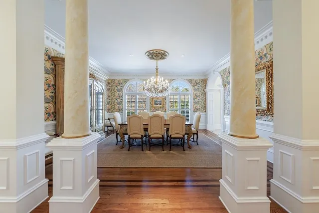 a dining room with furniture wooden floor and a chandelier