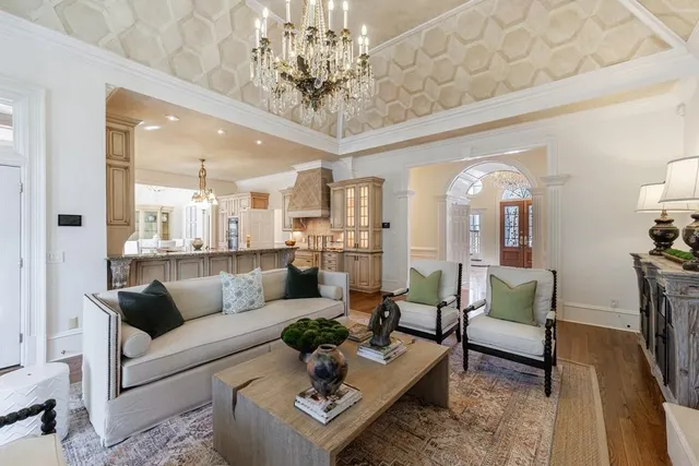 a bathroom with a granite countertop sink a large mirror and a bathtub